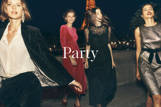 Four women in evening wear with the word 'Party' in front of a cityscape at night.