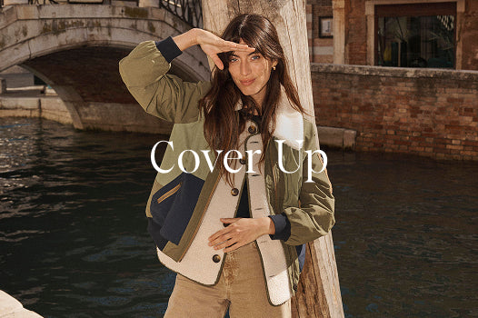Woman posing by a waterfront with 'Cover Up' text overlay