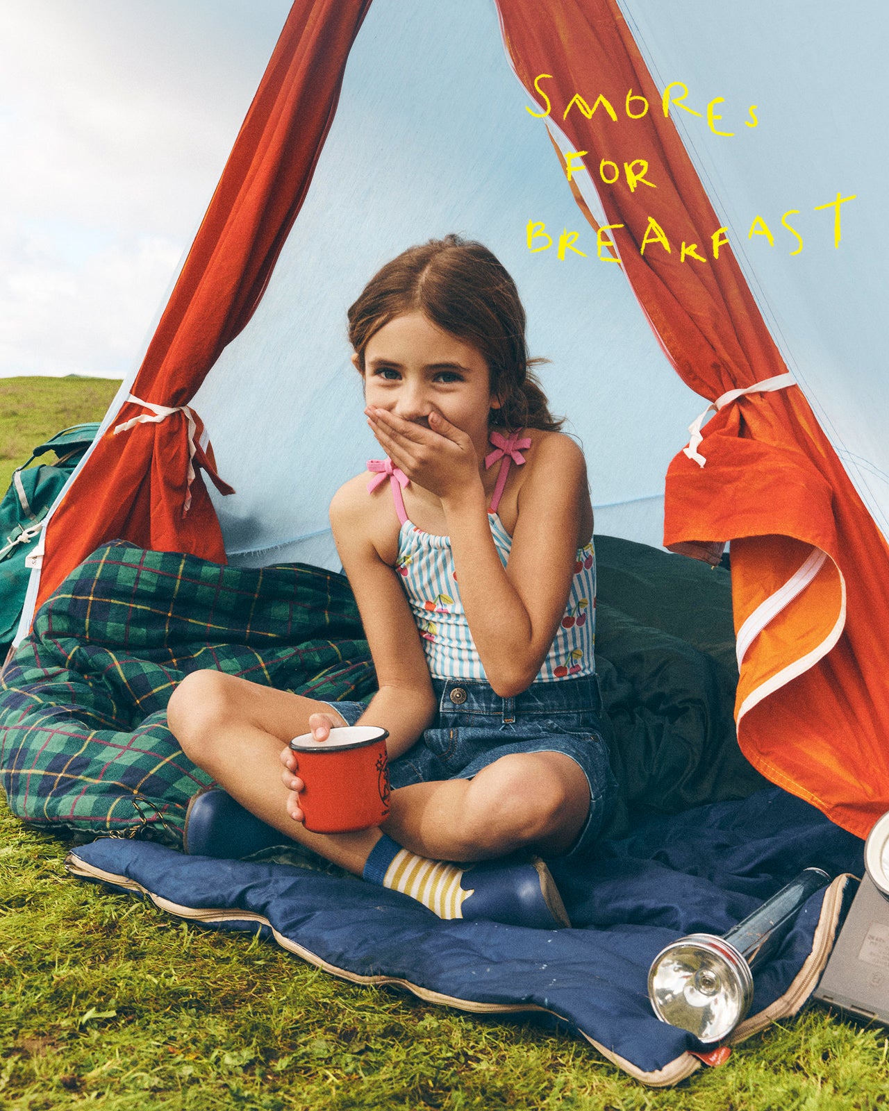 Young girl camping outdoors with a tent and 'S'mores for Breakfast' text.