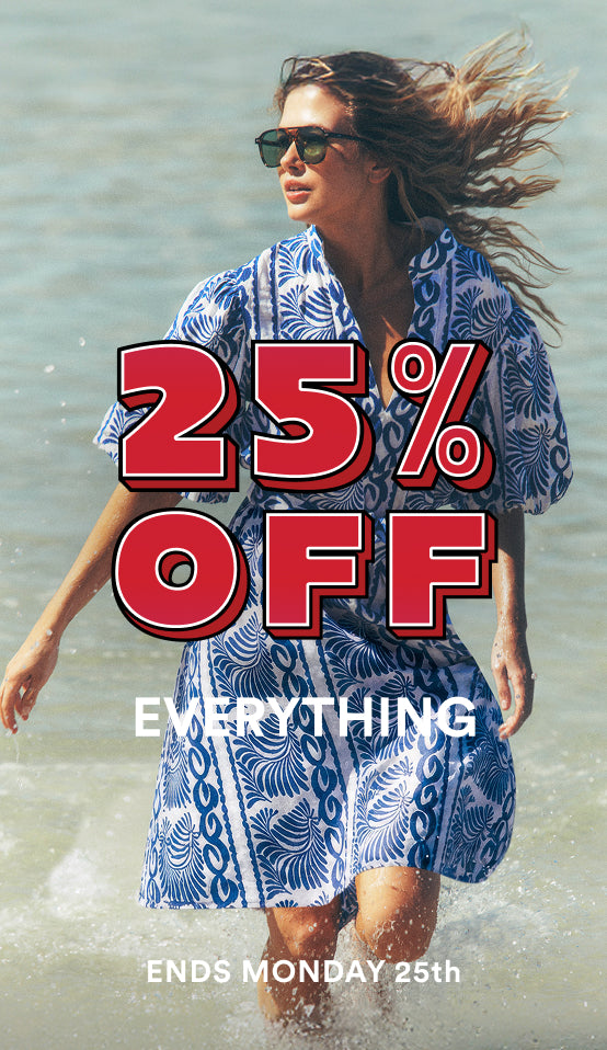 Woman in a blue patterned dress walking on a beach with promotional text overlay.
