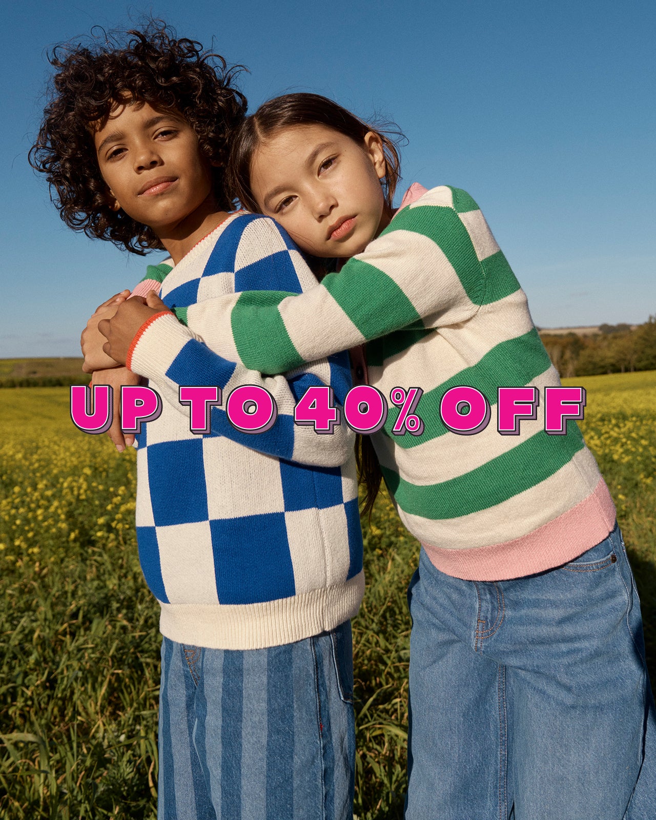 Two children hugging in a field with promotional text overlay