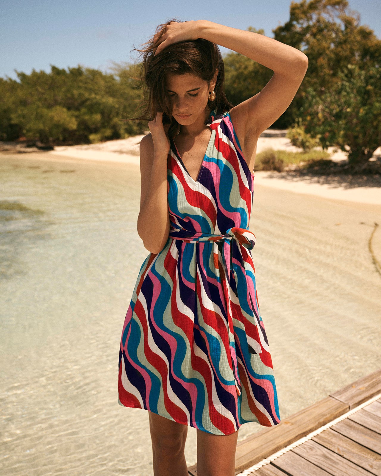 Woman in a colorful dress standing on a beach