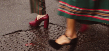Photo of the shoes of two women walking in the rain