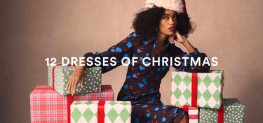 Woman in a patterned dress sitting on Christmas presents with text '12 Dresses of Christmas' on a beige background