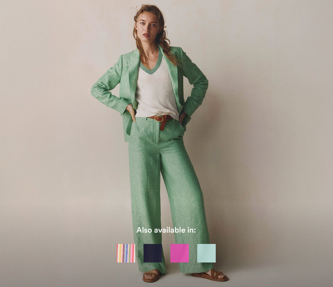 Woman wearing a green suit with a plain background and color swatches below.