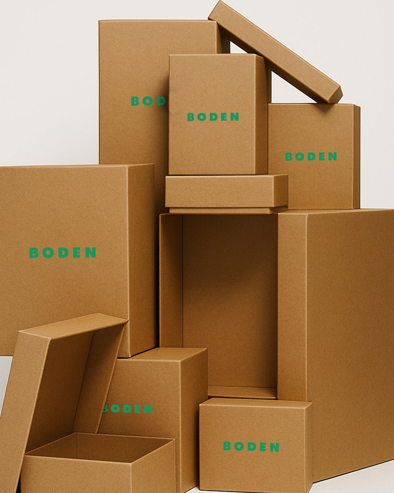 Stack of brown cardboard boxes with 'BODEN' branding on a light gray background