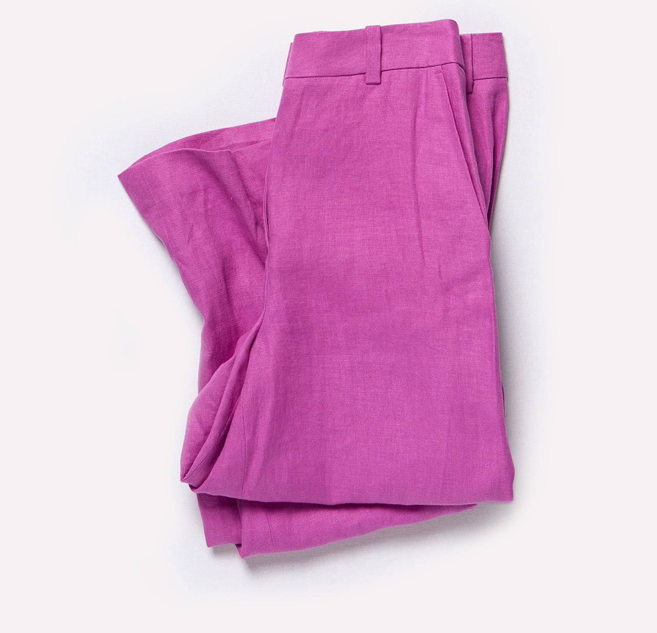Folded pink pants on a white background