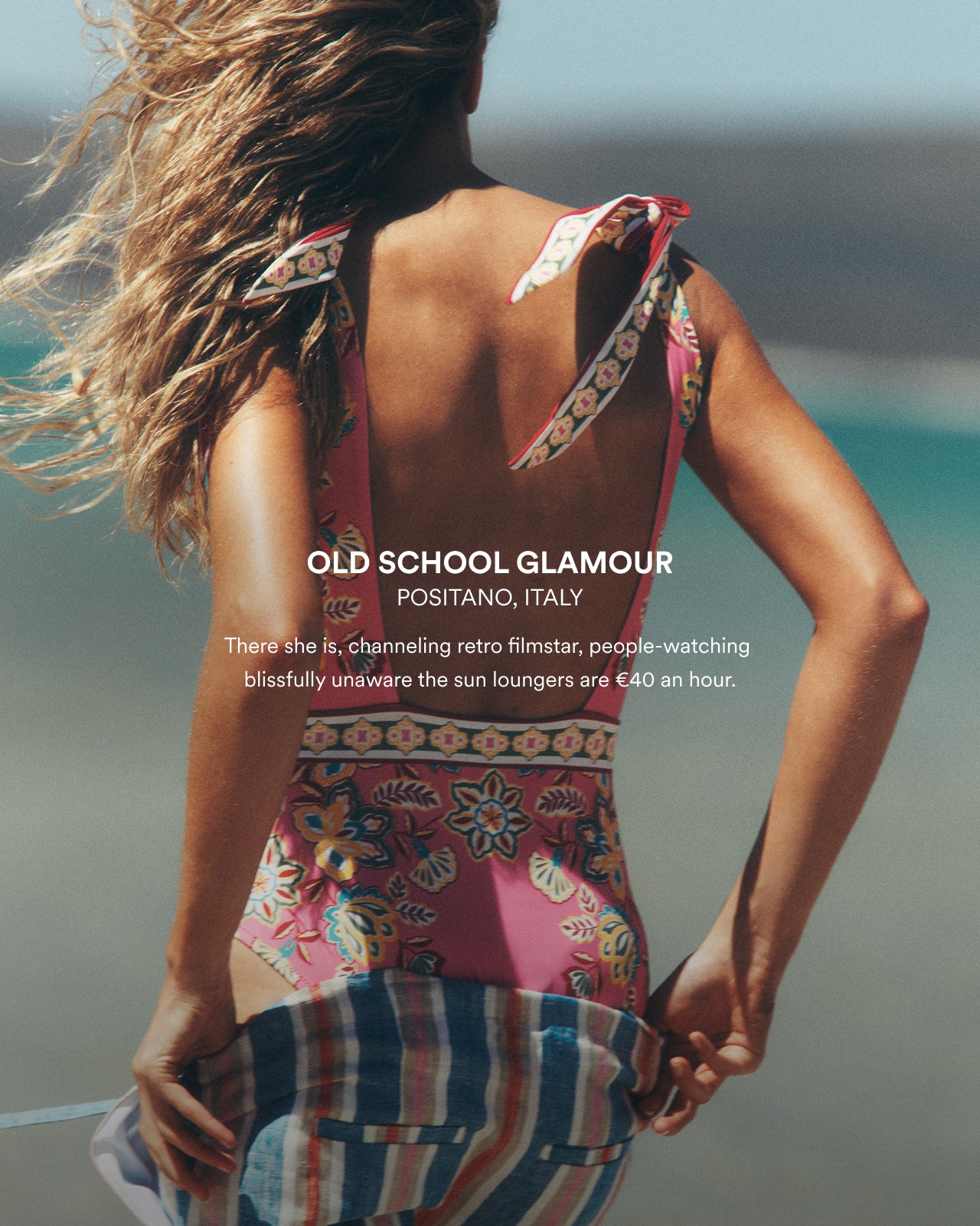 Woman in a colorful dress standing by the ocean with text overlay.