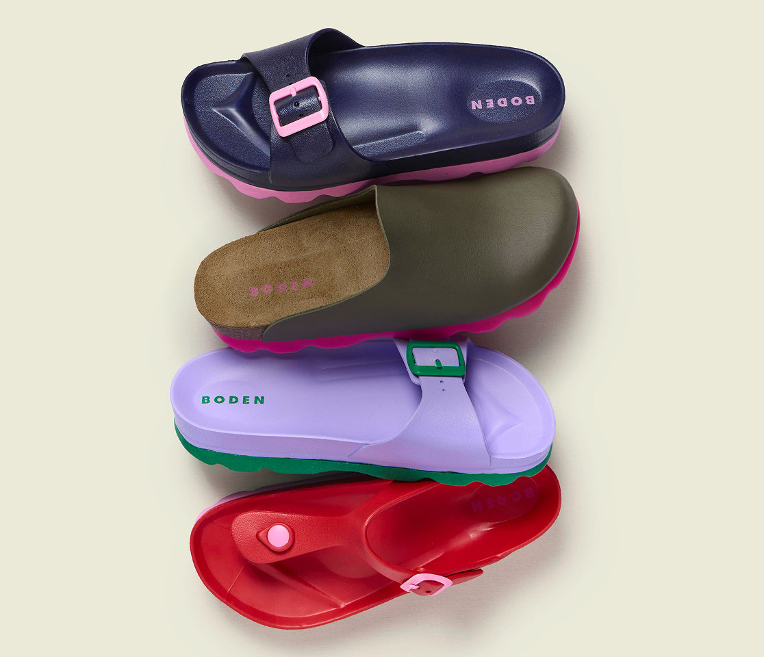 Four pairs of colorful sandals with 'Boden' branding on a beige background