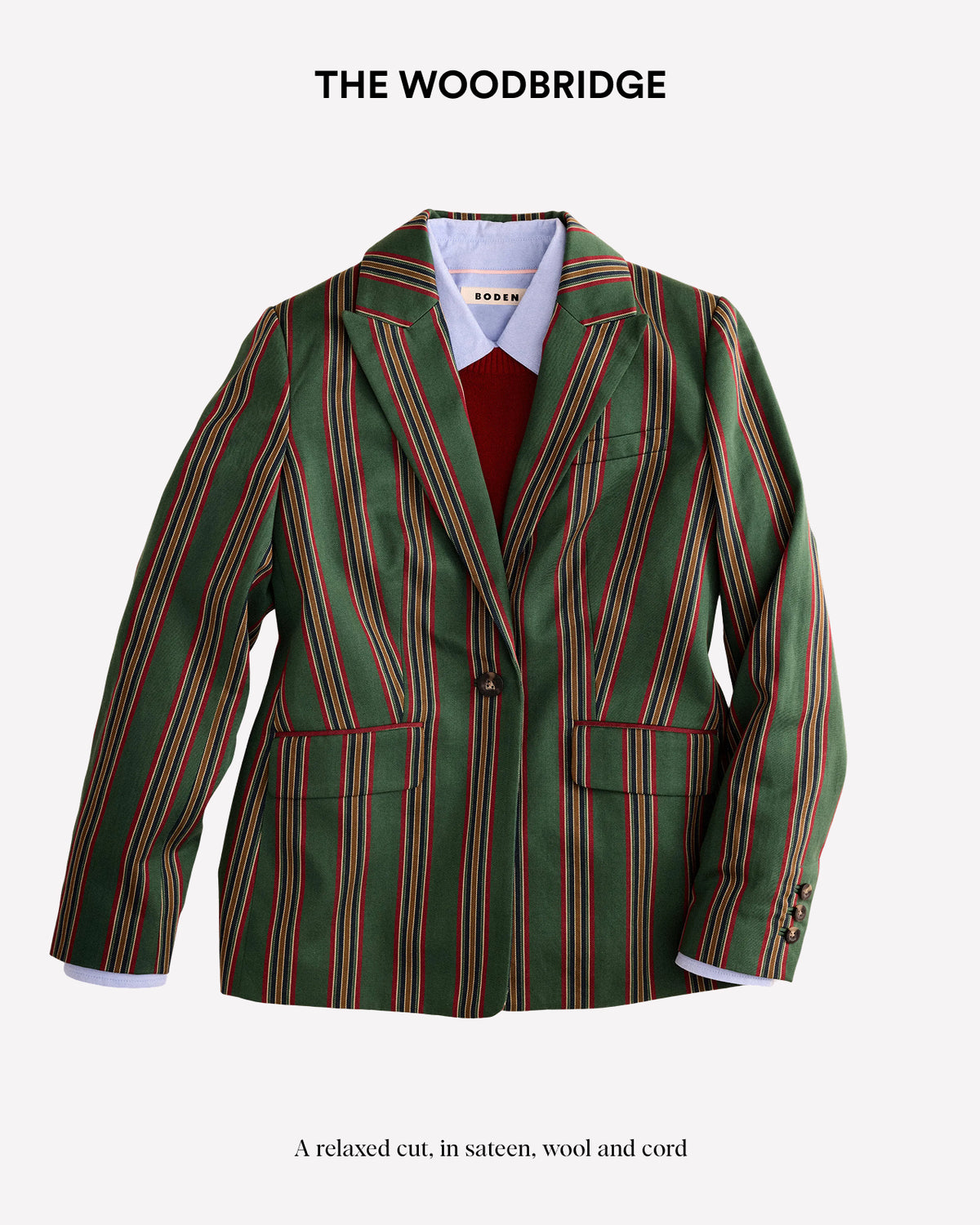 A green tailored blazer with vertical red and gold pinstripes, styled over a white collared shirt and red sweater, on a light gray background with 'THE WOODBRIDGE' text above.