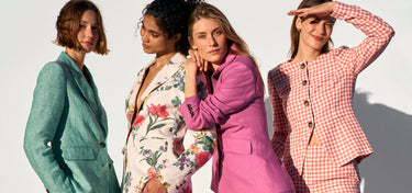 Four women in stylish outfits against a white background