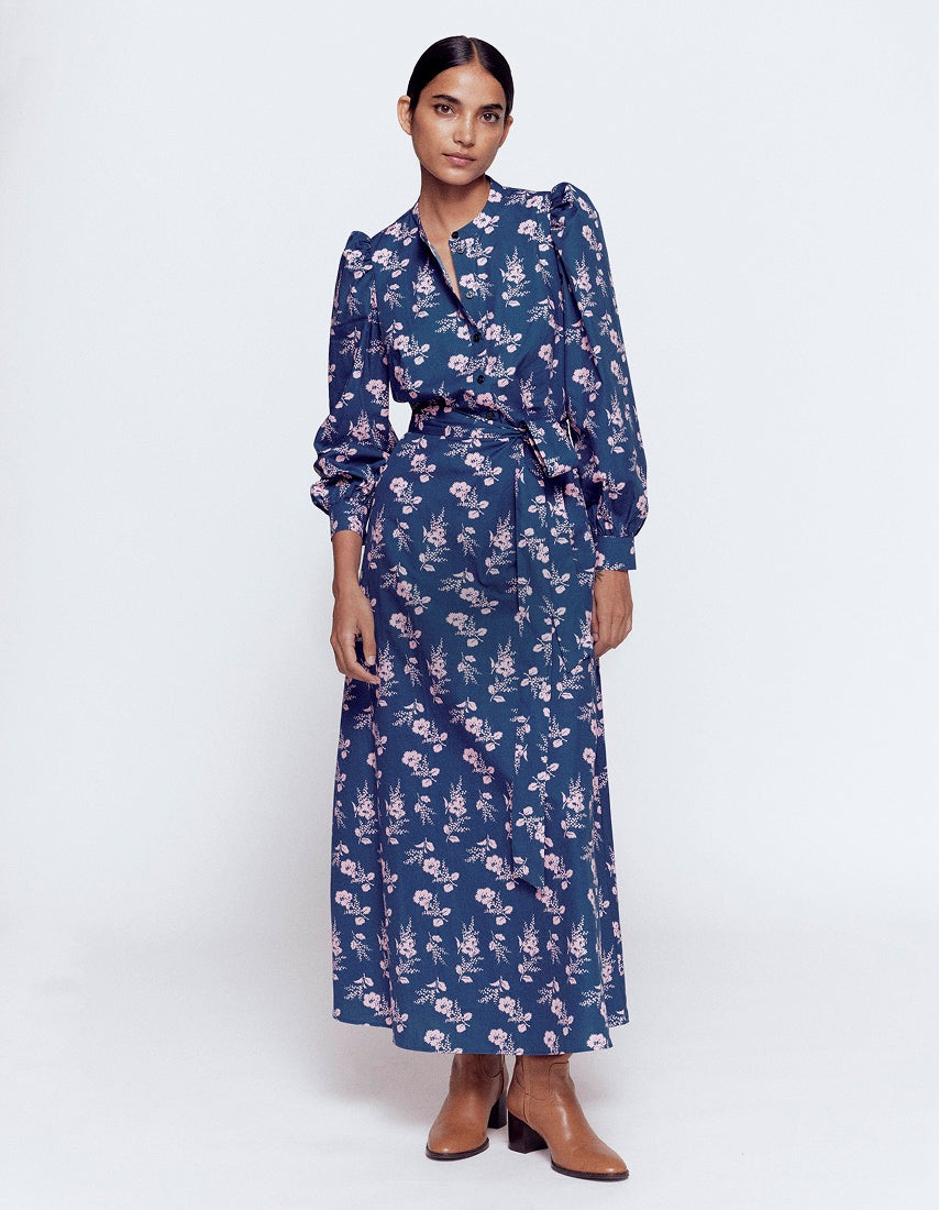 Woman wearing a blue floral dress on a white background