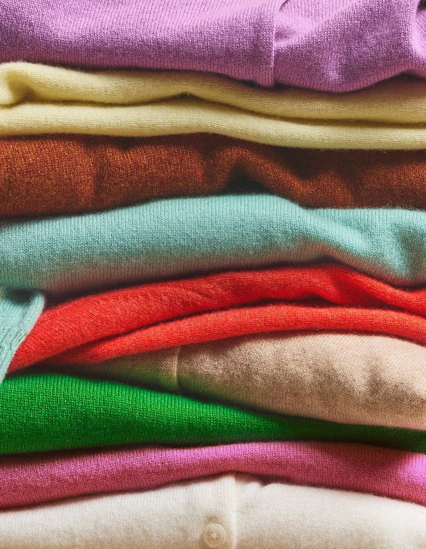Stack of colorful folded cashmere clothes
