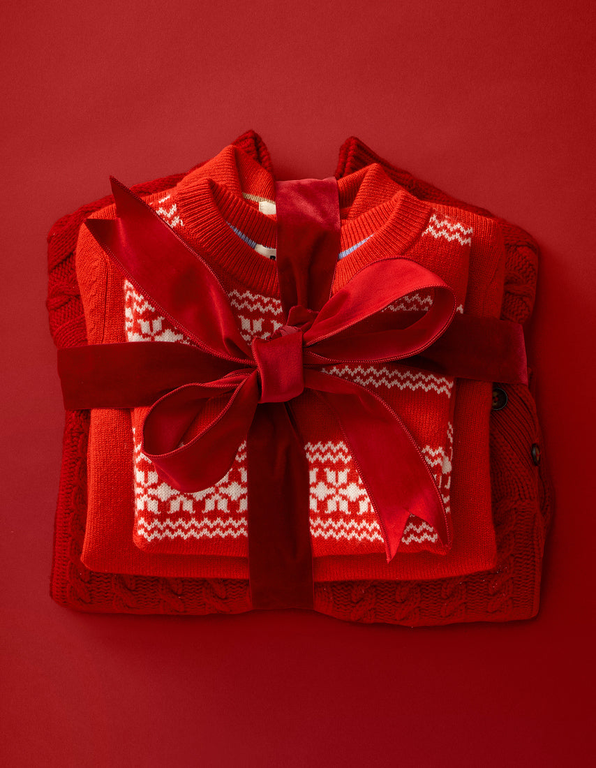 Red sweater with a large bow on a red background