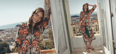 A woman modeling a long-sleeve midi dress with a vibrant orange, red, green, and black floral pattern, shown in a split-screen lifestyle format from two different outdoor balcony locations.