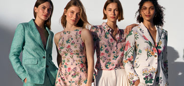 Four women wearing floral and patterned outfits against a neutral background