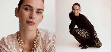 Woman wearing a gold necklace with a plain background