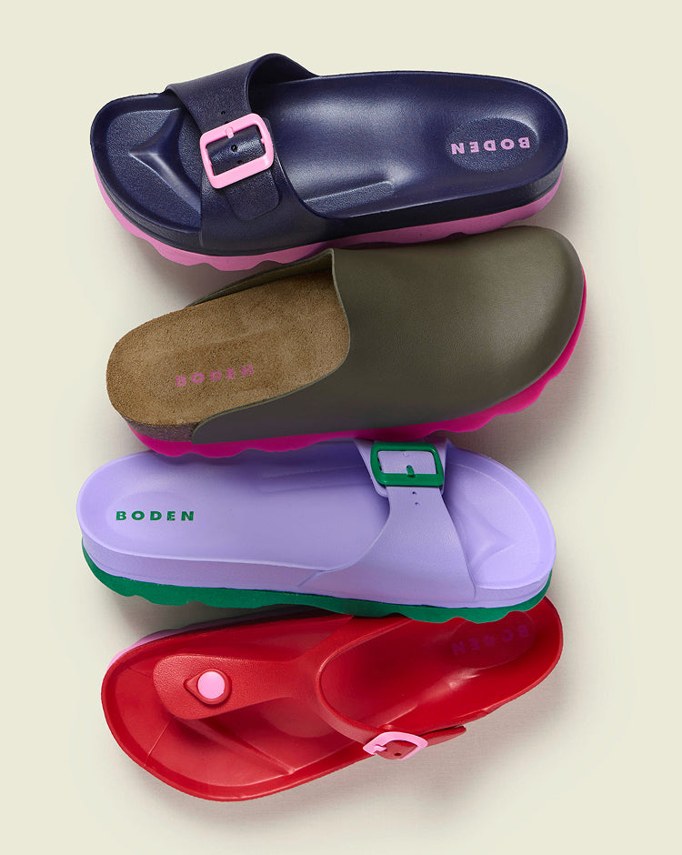 Four pairs of colorful sandals with 'Boden' branding on a beige background