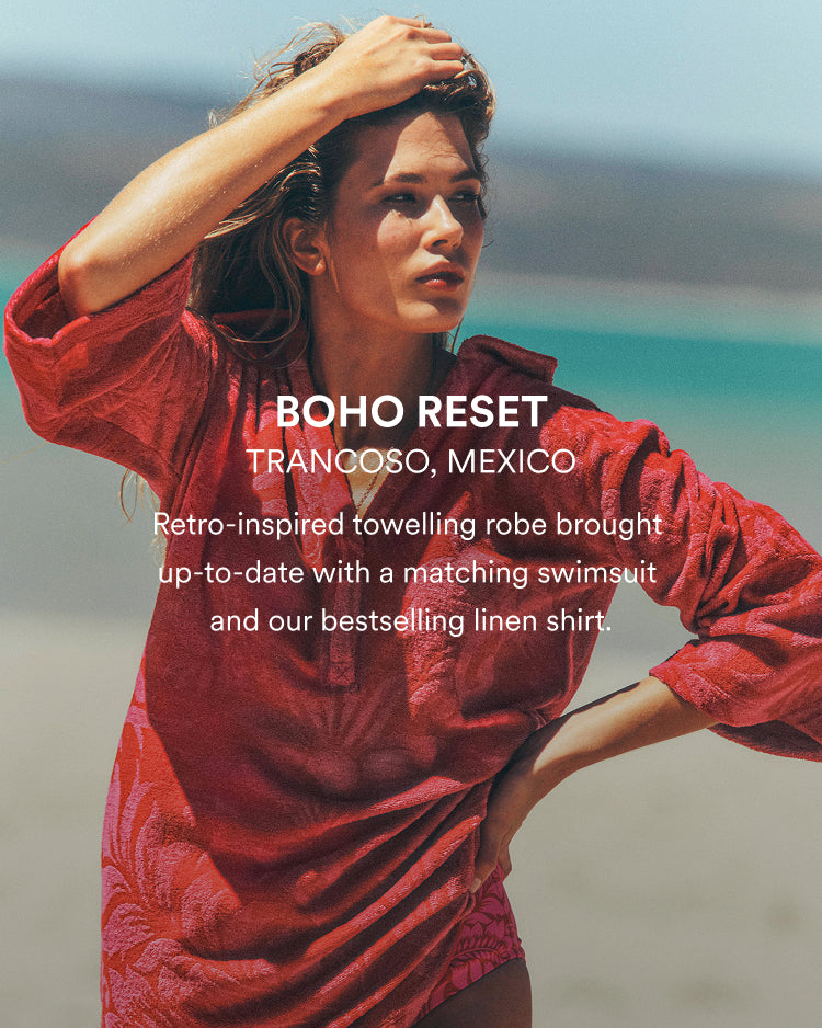 Woman in a red robe and swimsuit on a beach with text overlay.