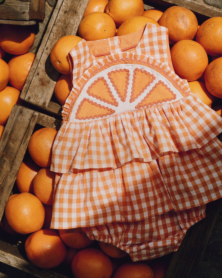 Orange checkered dress on a background of oranges
