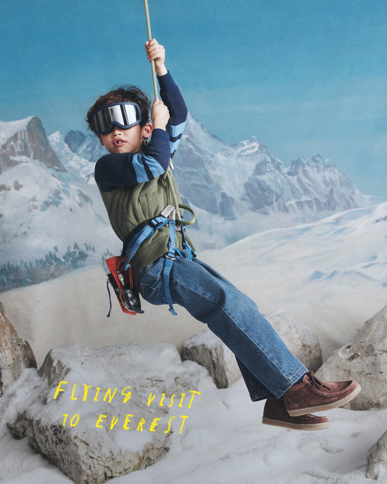 Person rappelling on a snowy mountain with 'Flying Visit to Everest' text.